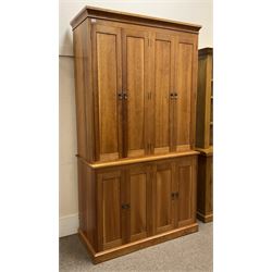 American cherry wood wall unit, top section fitted with two double cupboards enclosing shelves, lower section with four cupboard doors concealing six drawers