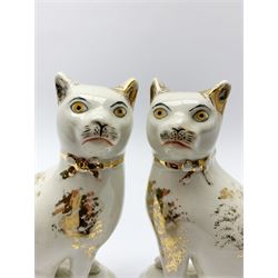 Pair of Victorian Staffordshire cats, modelled seated upon cushions, with gilt detail throughout, H18cm