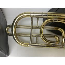 Three brass trombones comprising Elkhart Ind. USA 'CONN' model no.72H; Besson 'Concord'; and Selmer Distributed 'Lincoln'; two in carrying cases; and German B & M 'Champion' brass trumpet (4)