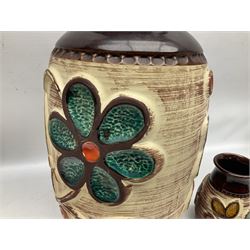 Pair of Bay West German vases, with bold moulded flower and foliage decoration in green, orange and ochre on brown ground, largest H40cm