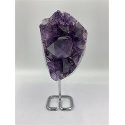 Amethyst crystal geode cluster, with large well-defined crystals, upon a metal stand, H21cm