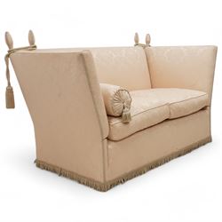 Knole design hardwood-framed drop-arm two-seat sofa, upholstered in cream Damask fabric decorated with repeating foliate pattern, with twist fringe, 