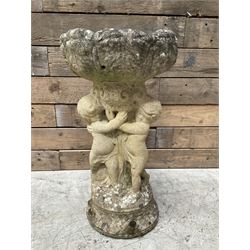 Weathered cast stone birdbath, pedestal in the form of playful Putti