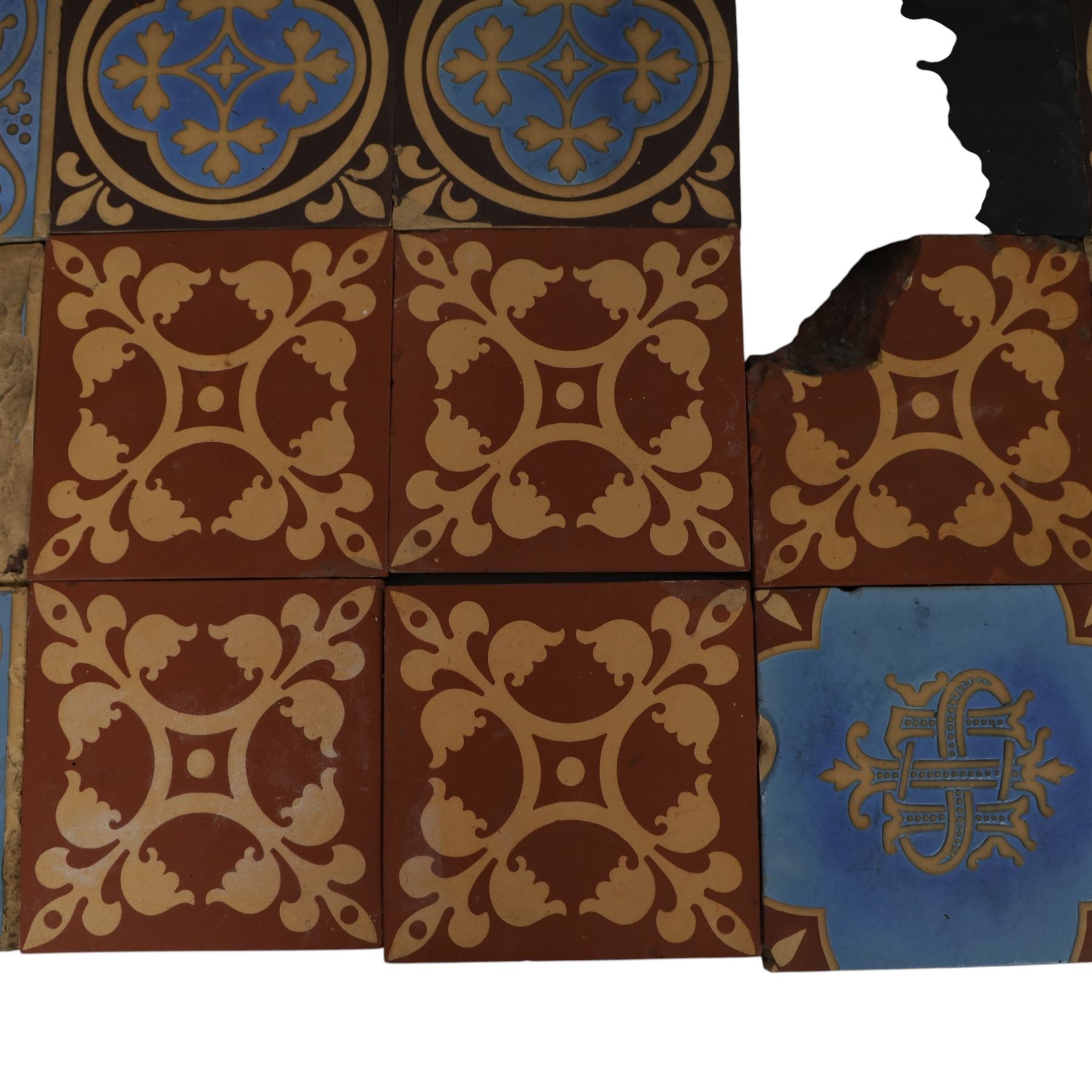 Minton & Co, Gothic Revival polychrome encaustic floor tiles, circa 1850, including six decorated with a central cardinal quatrefoil upon a blue ground, boarder tiles with scrolling vines and similar