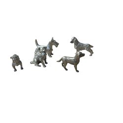 Five white metal figures, modelled as dogs, largest H7cm