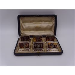 Set of six early 20th century silver mounted tortoiseshell place card holders by Asprey, the rectangular silver reed and ribbon frame bordering a central tortoiseshell panel inlaid with a silver floral motif, upon an oblong foot, hallmarked Asprey & Co Ltd, London 1913, H3cm, contained within a tooled leather fitted case with velvet and silk lined interior 