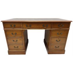 Cherrywood twin pedestal desk, rectangular leather inset top over central fall front with keyboard slide and two drawers, fitted with two drawers and cupboard, on bracket feet