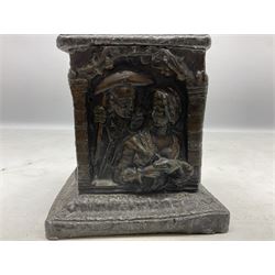 19th century lead tobacco box, the body of square form decorated with panels of courting couples in relief supporting stepped tapering lid with figural male head finial, H18.5cm