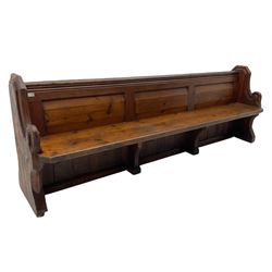 Victorian pine church pew, moulded cresting rail over triple panelled back, shaped end supports joined by plank seat