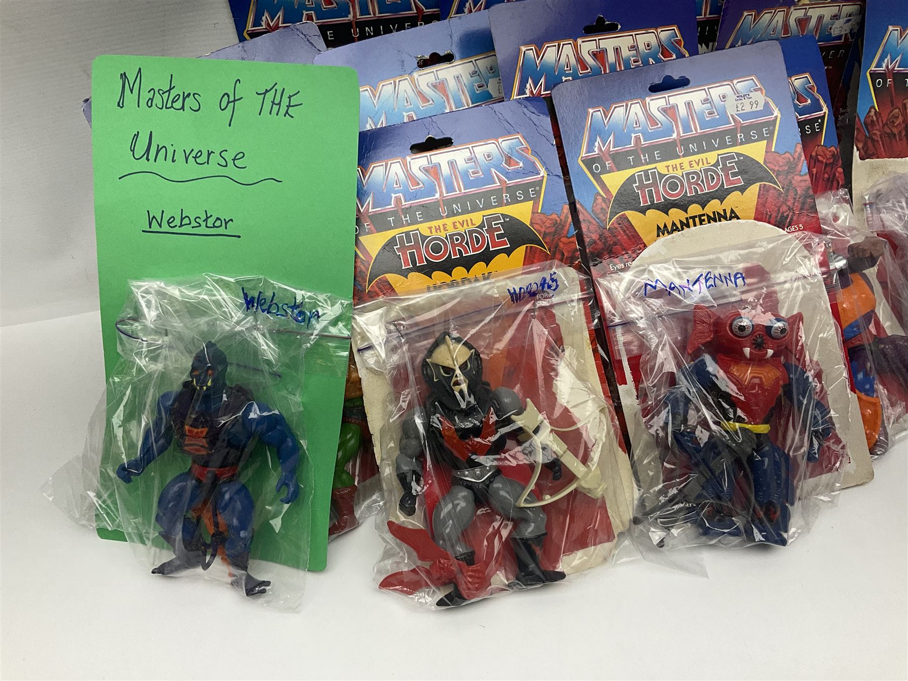 Thirty-one Masters of the Universe He-Man figures re-bagged on original backing cards;  two others lacking backing cards; boxed Modulok figure; bag of weapons and accessories; Roton, two horses and two battle cats; 1986 & 1987 Annuals; Ladybird and other story books; Panini sticker album; instructions etc