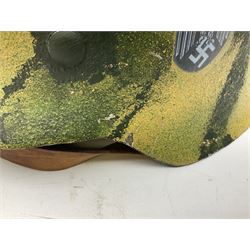 Fully restored German steel helmet, the camouflage painted exterior with two decals and replacement leather liner