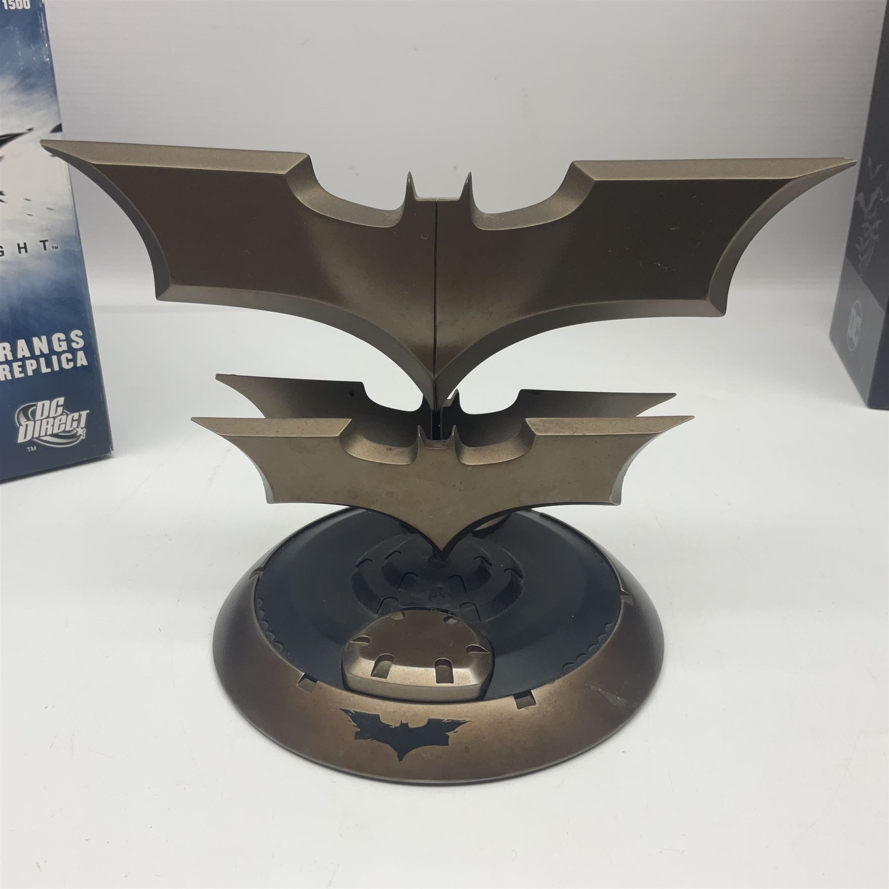 Two Batman replica Batarangs comprising DC Comics QMX Caliber Metalworks 1:1 scale replica with original box, and DC Direct The Dark Knight prop replica no. 33/1500 with original box and certificate of authenticity 
