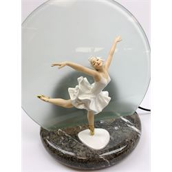 A table lamp with circular frosted glass shade, behind a later mounted continental figure modelled as a ballet dancer, H37cm. 