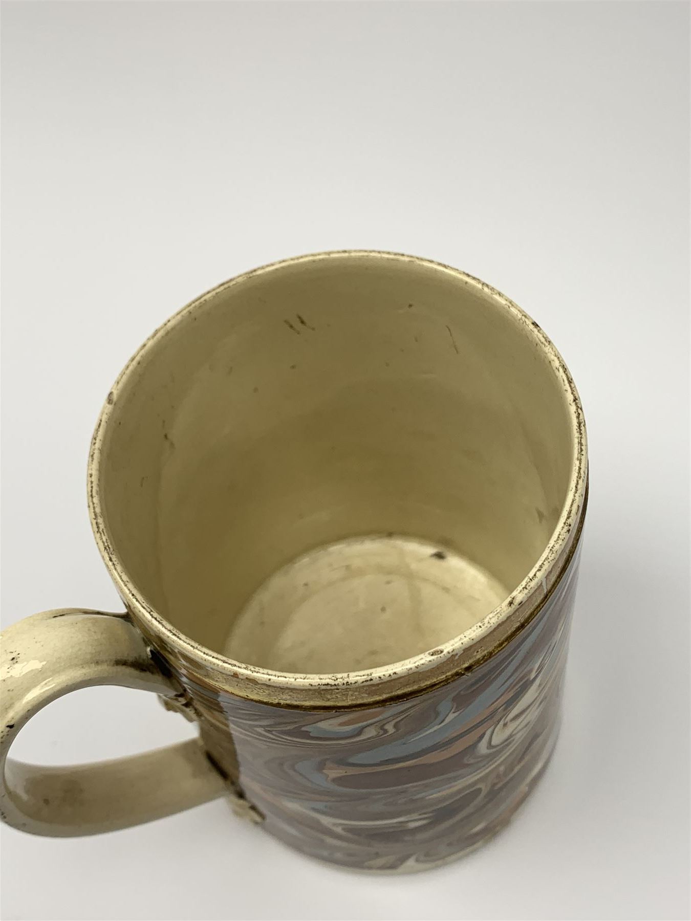 Late 18th century earthenware mug, possibly Ralph Wedgwood, Burslem or Ferrybridge, with surface marbled decoration and later gilt detail to rims and handle, impressed beneath Wedgwood & Co, H12cm