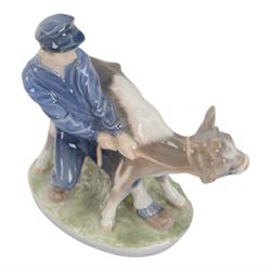 Five Royal Copenhagen porcelain figures of farm animals, comprising Boy with Pig no 848, Boy with Calf no.772, Boy with Sheep no 627, Boy with Calf's no.1858, Girl with Goats no 694