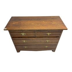 Edwardian oak straight front chest, fitted with two short and two long drawers with brass handles, raised on bracket feet
