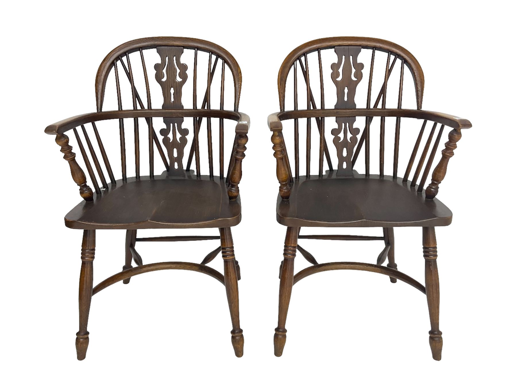 Pair late 20th century oak Windsor elbow chairs, double hoop and stick back with pierced and fretwork work splat, dished seat on turned supports joined by crinoline stretcher