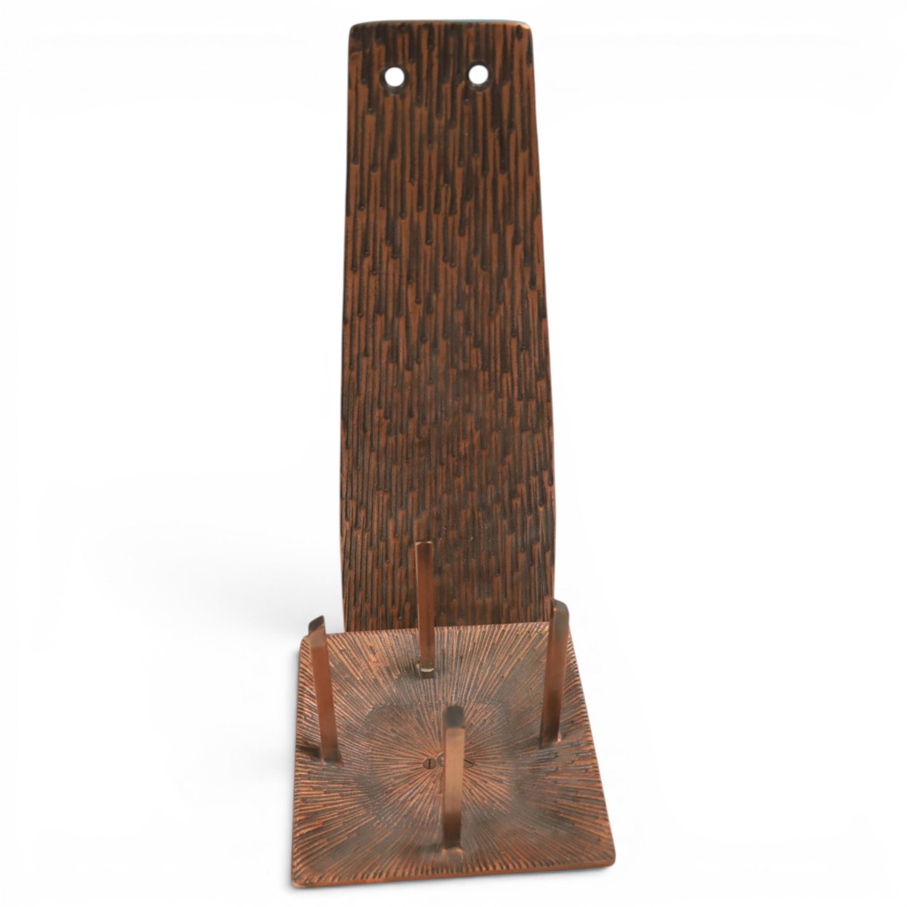 Pair of brutalist candle holders, together with similar wall sconce