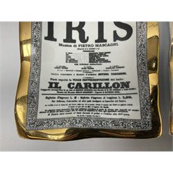 Two Fornasetti rectangular operatic posters ashtrays 'Norma' and 'Iris' decorated with black and white text with a gilt border edge, with printed mark beneath, H16cm