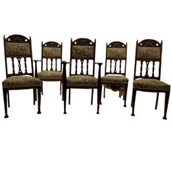 Set five early 20th century Arts & Crafts style oak dining chairs, the cresting rails carved with green man mask, cushioned back over shaped pierced splats, two carvers and three side chair 