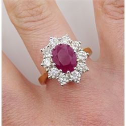 18ct gold oval ruby and round brilliant cut diamond cluster ring, stamped 750, ruby approx 2.25 carat, total diamond weight approx 1.50 carat