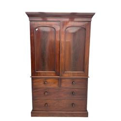 Victorian mahogany linen press, projecting moulded cornice, two doors with arched panels enclosed four linen slides, the lower section fitted with two short and two long drawers, on plinth base