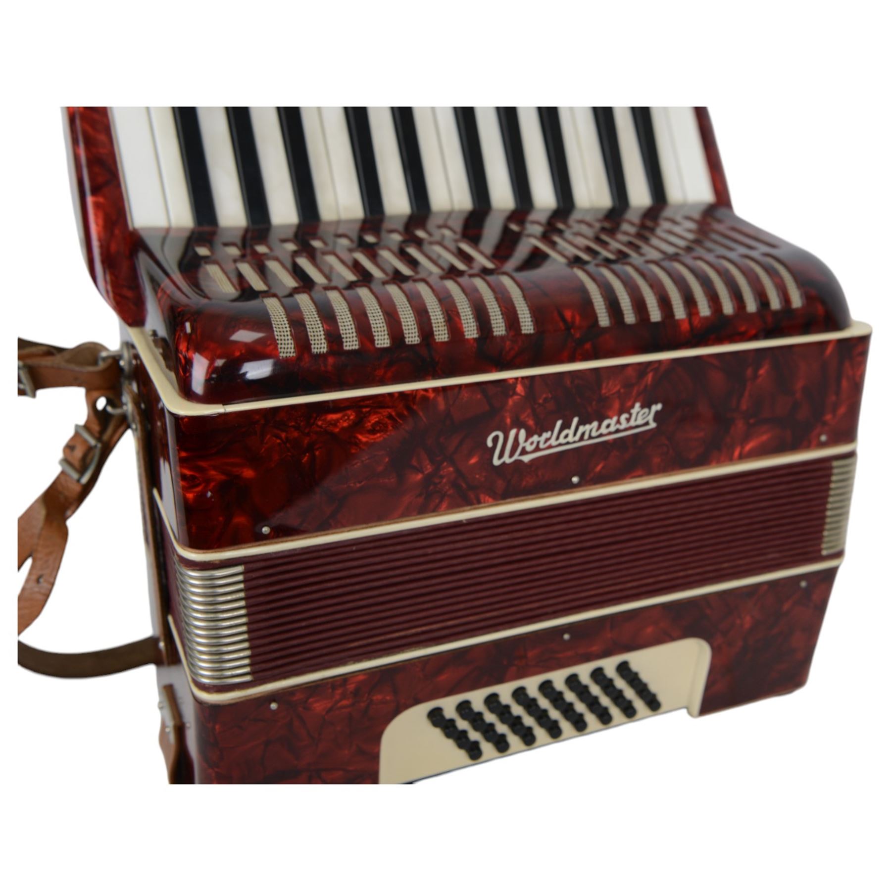 World master piano accordion with  14 fold bellows, two octave keyboard and 32 buttons. With a hard carrying case.