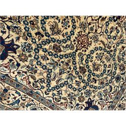 Persian Kashan ivory ground rug, wool with silk inlay, central floral rosette medallion surrounded by trailing flower heads and interlacing leafy branches, the repeating scrolling border decorated with palmettes, within guard stripes