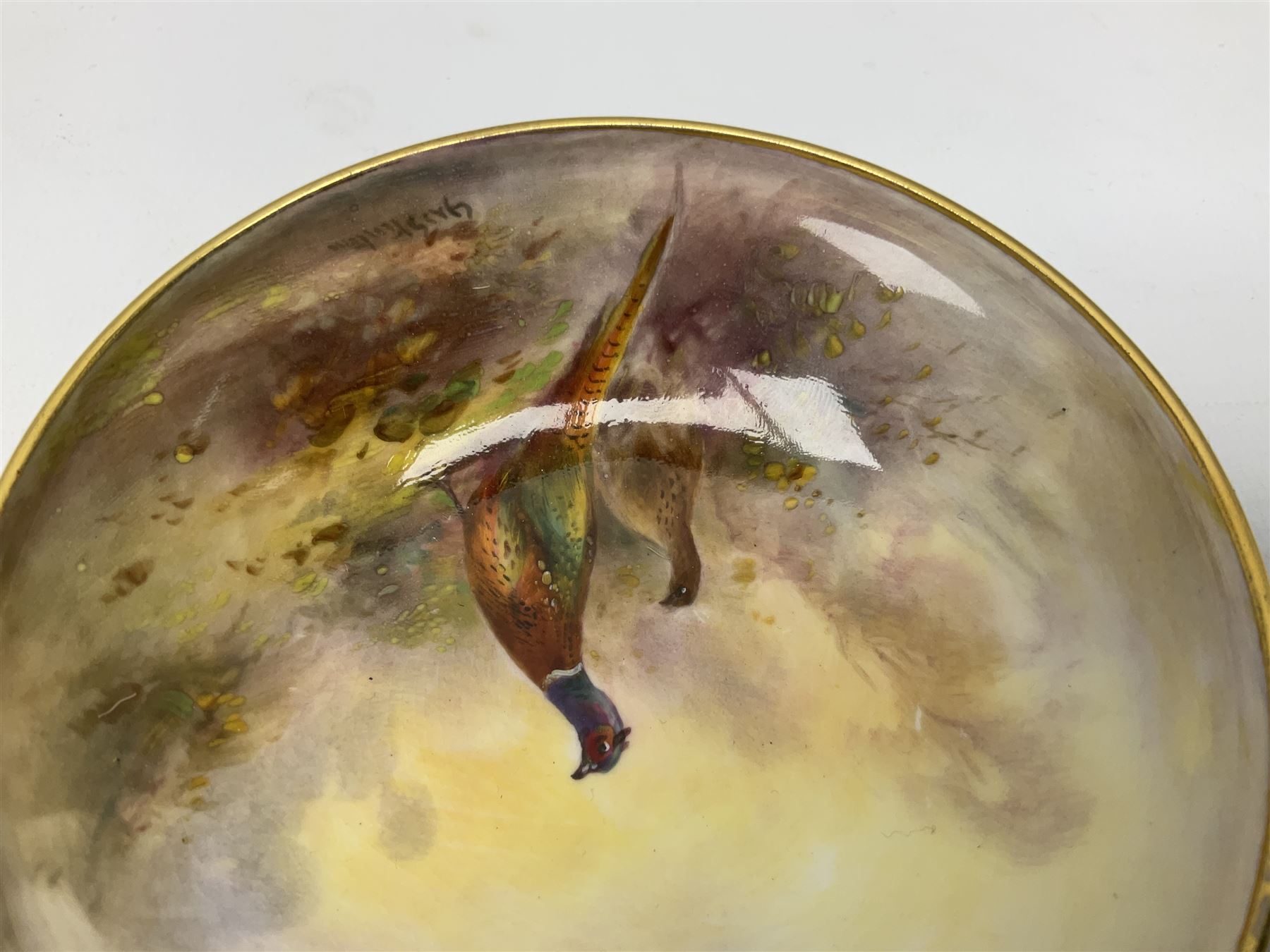1938 Royal Worcester circular pedestal pin dish, decorated with pheasants in a landscape by James Stinton, with printed mark beneath, D10.5cm