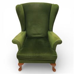 Parker Knoll - pair of 'Penhurst' wingback armchairs upholstered in olive green fabric, on light stained supports 