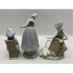 Three Lladro figures, comprising, Flower Harmonay no 1418, Milkmaid no 5718, and avoiding the goose no 5033, all with individual boxes, largest example H25cm 
