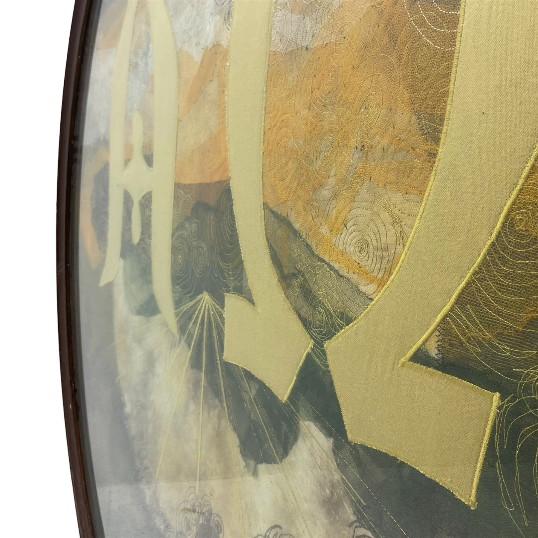 Circular needlework panel depicting Alpha and Omega symbols upon a sunset landscape scene with raised gilt stitching in wooden frame, signed ‘E. Burn’ in thread