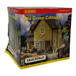 Ten Hornby '00' gauge Skaledale buildings, comprising R8505 The Kings Head Hotel, R8518 Old Green Cottages, R9716 City Dry Cleaners, R9678 Emma Williams Ladies Outfitters, R9800 Bus Shelter, R8637 Double Engine Shed, R8519 Misdale House, R8709 Fuel Oil Tanks, R8630 Toilet Block and R8603 Coal Staithes, all boxed