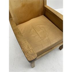 'Mouseman' oak smokers armchair, panelled sides, slung tan leather back and upholstered seat cushion, by Robert Thompson of Kilburn