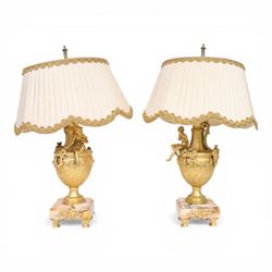 Pair of Rococo style gilt metal table lamps, the urn shaped bodies each with applied figur...