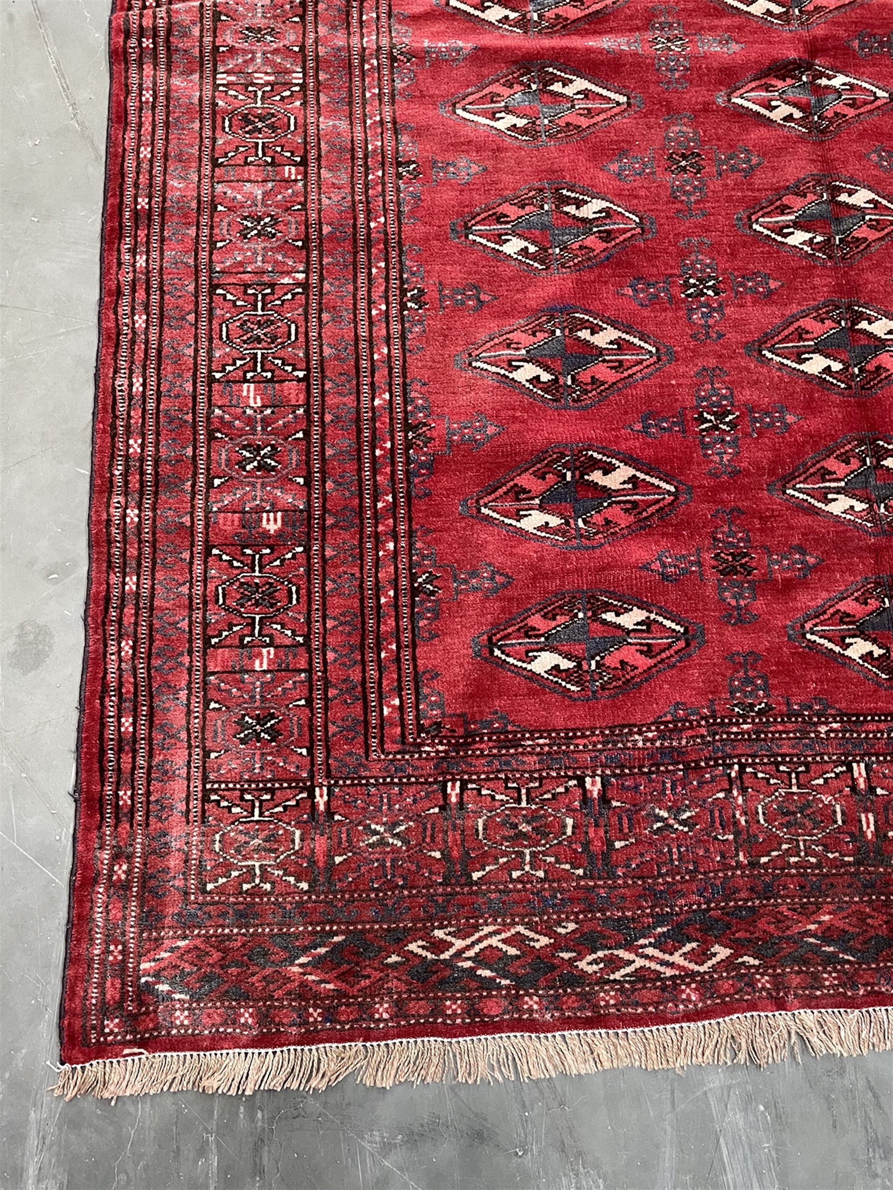 Turkman Bokhara rug, red ground field decorated with repeating Gul motifs
