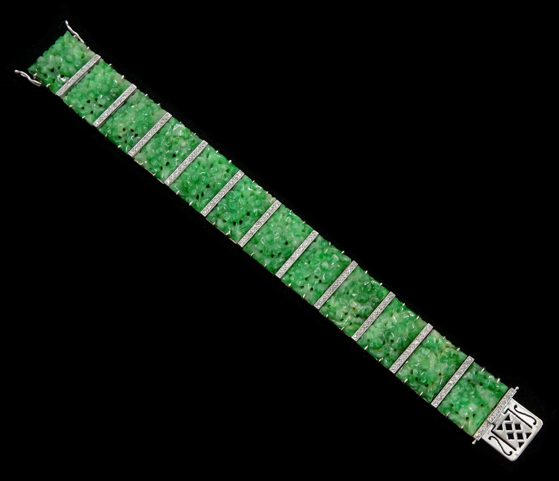 Art Deco platinum and white gold jadeite and diamond bracelet, twelve carved foliate jadeite panels, separated by a row of milgrain set old cut diamonds