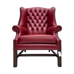 Kingsgate - contemporary 'Suffolk' wingback armchair and matching stool, upholstered in red leather with deep button tufting and brass stud trim, raised on square section supports 