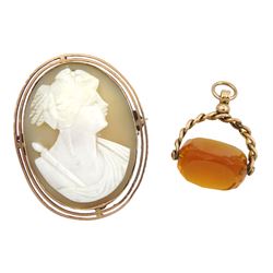 Early 20th century rose gold cameo brooch, stamped 9ct and a gold orange glass set swivel fob, stamped 9.375 