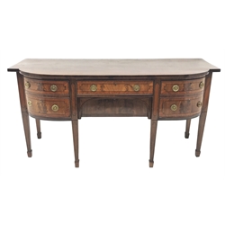 George III satinwood banded mahogany bow breakfront sideboard, three drawers and one cupboard, the figured drawer fronts with geometric ebony stringing, on square tapering supports on spade feet, W189cm, H91cm, D69cm
