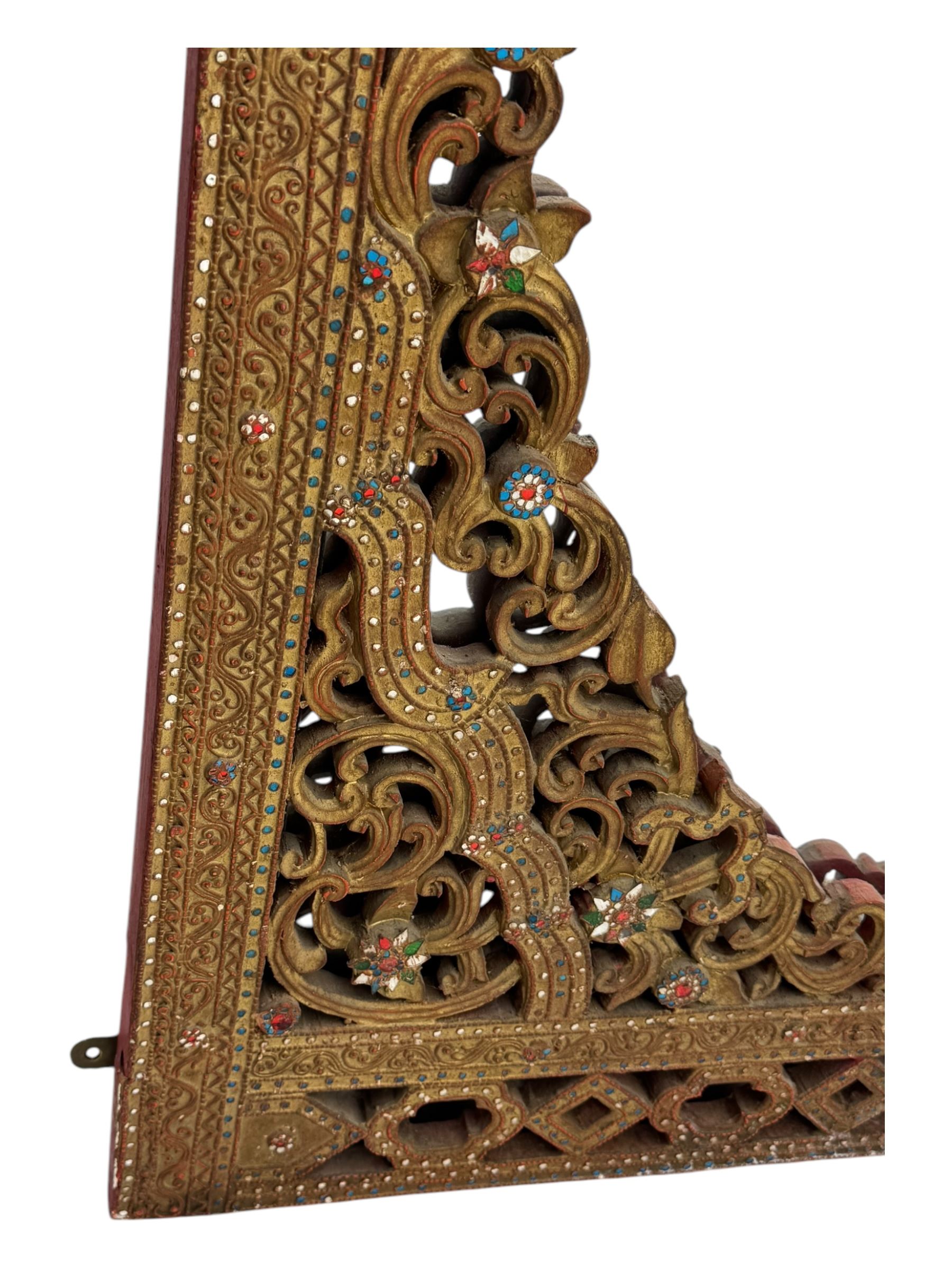 Large North African design carved and painted wall mirror, decorated with floral motifs, pierced foliate scrolls, inset mirrored panels, and colourful painted detailing, enclosing an oval bevelled mirror plate