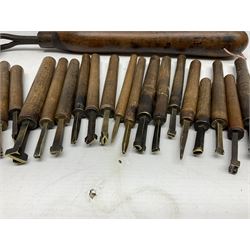 Thirty-one bookbinder's brass number and letter stamps, predominantly with beech handles, together with a bookbinder' decorative fillet roll, with brass triple line wheel stamped E. Menuel London, with wood handle, and two ink blotters