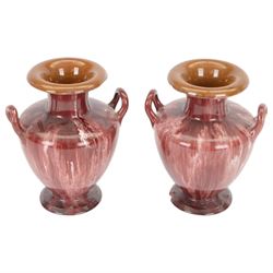 Linthorpe Pottery, pair of twin handled vases, with a purple glaze, H20cm