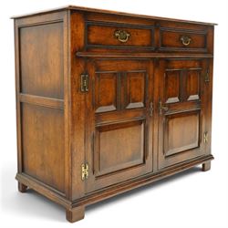 18th century style oak dresser base, rectangular moulded top over two frieze drawers with brass handles, twin panelled cupboard doors below with pierced brass escutcheons, on stile feet