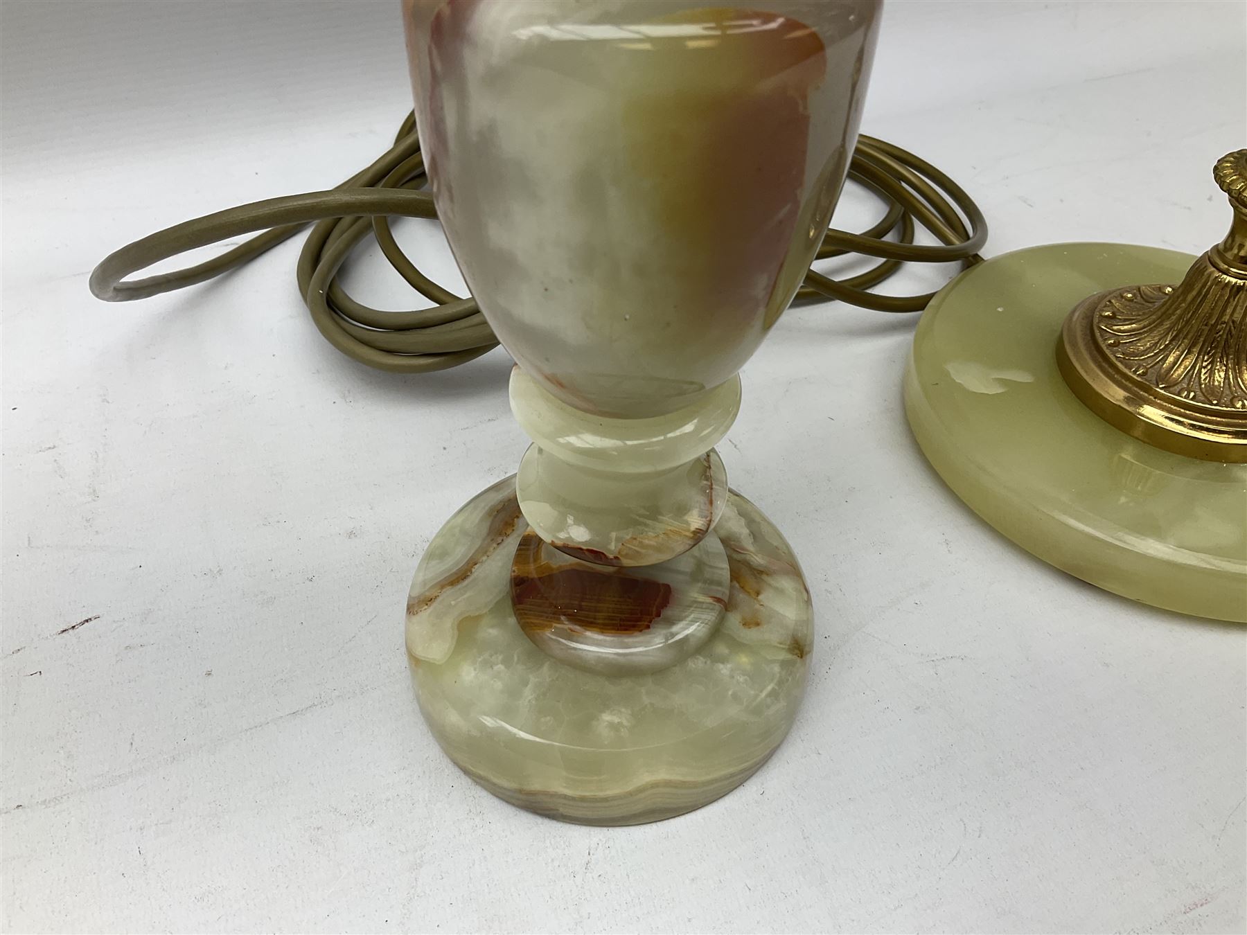  20th century gilt metal and onyx four branched candelabra upon a circular base, and onyx table lamp in the form of an urn, tallest example H48cm