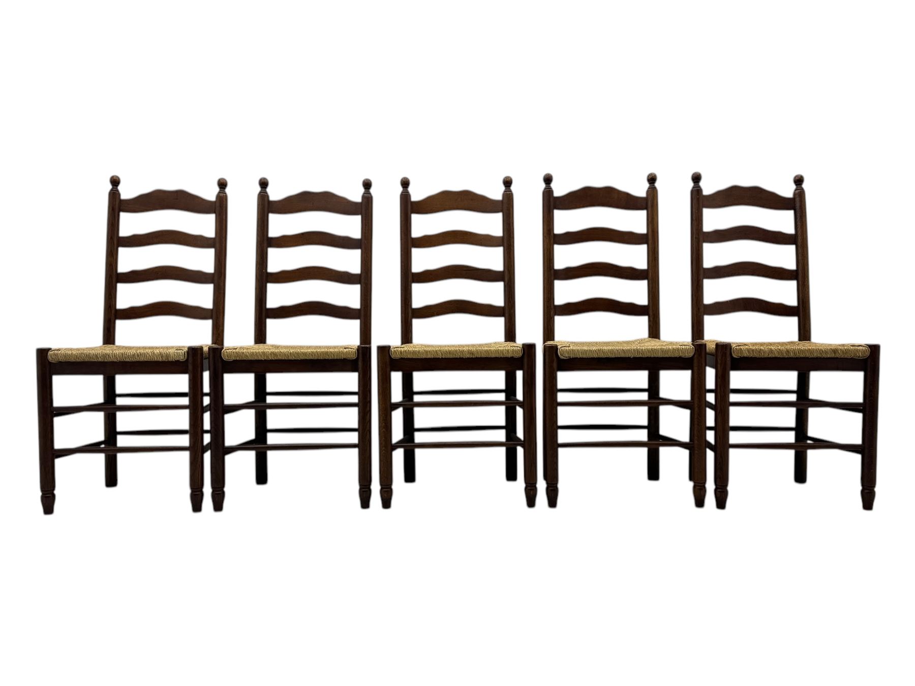 Set of ten 18th century design oak ladder back dining chairs, shaped cresting rail over four horizontal splats, rush seat raised on turned supports united by double stretchers