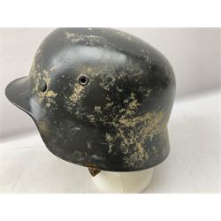 WW2 German steel helmet painted in undecaled Luftwaffe bluey grey with leather liner and chin strap stamped '58', the skirt impressed '1250'