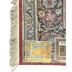 Persian design rug, rectangular crimson ground field with medallion, surrounded by trailing foliate branches, within wide border bands decorated with stylised floral motifs 