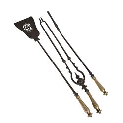 Set of three 19th century brass and steel fire irons, each with tapering and hexagonal capped handles, comprising poker, tongs and shovel with pierced detail, poker L84cm