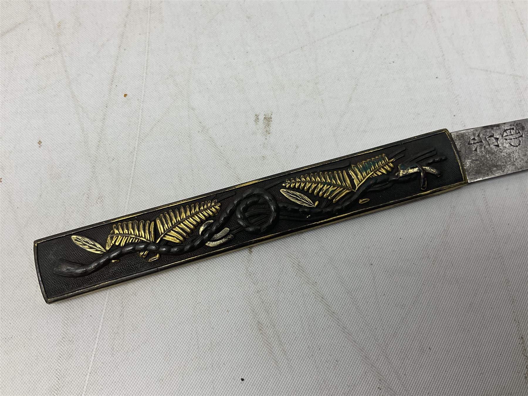 Japanese Tanto with 28.5cm steel blade and cord bound grip; in red spotted black lacquer saya containing a kogai knife with etched characters to the blade and ornate fern leaf and snake handle